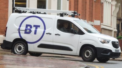 White BT van in front of building